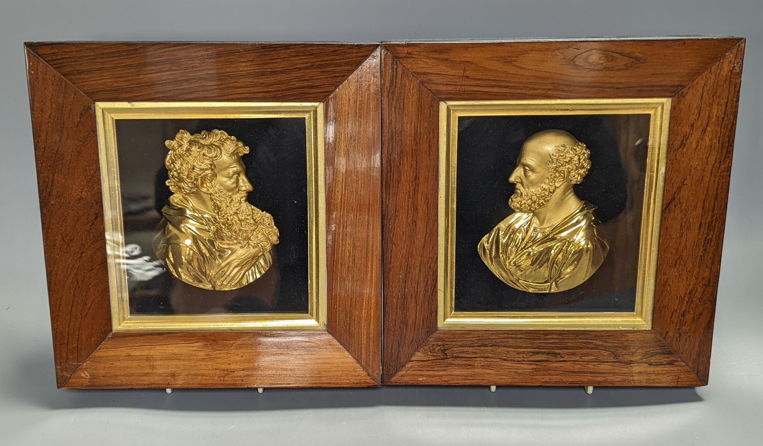 A pair of mid 19th century gilt-bronze portrait reliefs of Greek philosophers?, each in rosewood frames, width 23cm overall